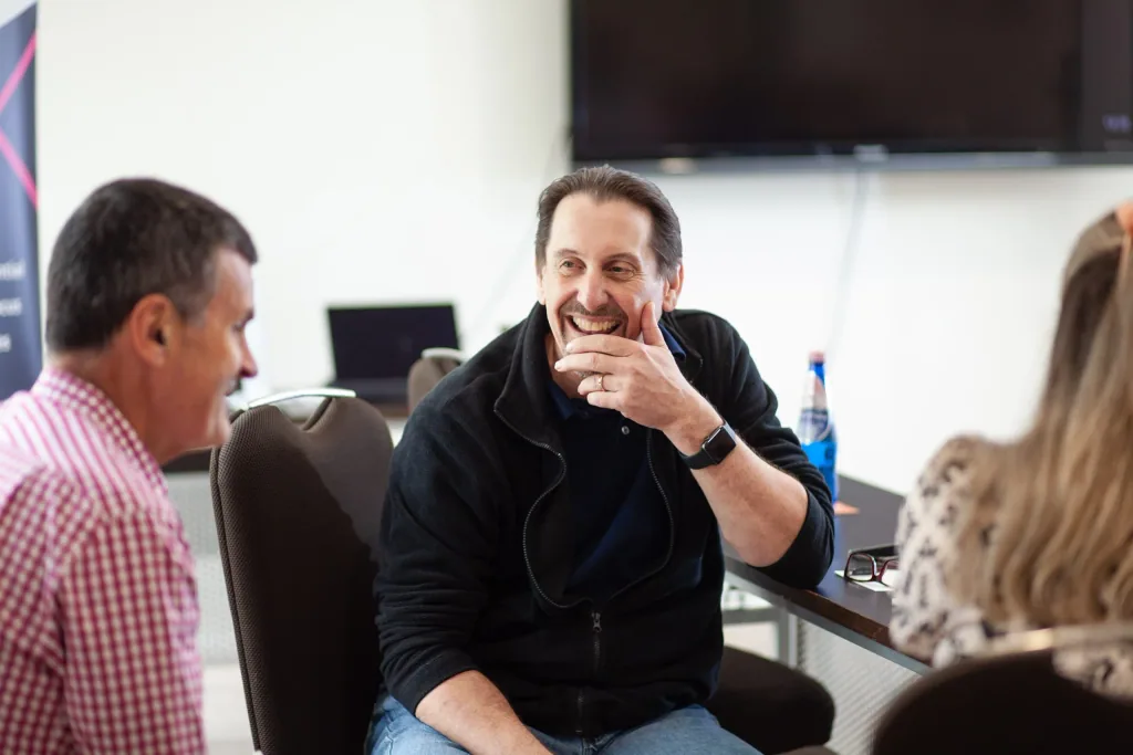 A Nexxt Group consultant in conversation with clients during a workshop